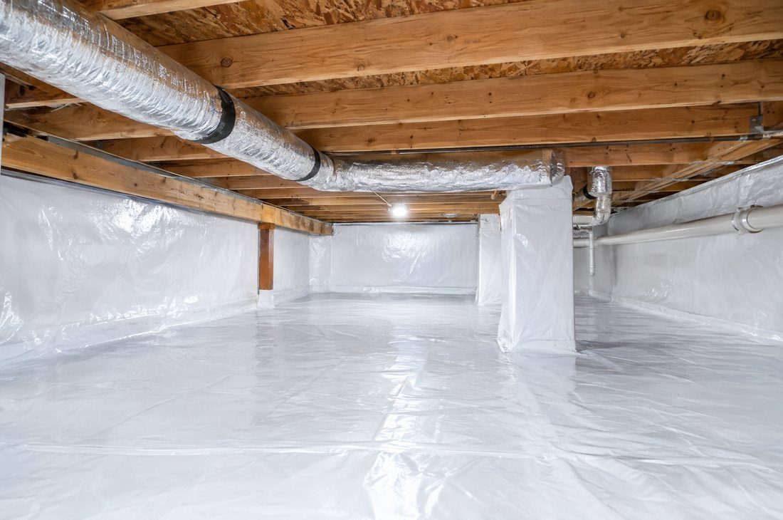 Clean, fully encapsulated crawl space with a bright white vapor barrier under a Charlotte home